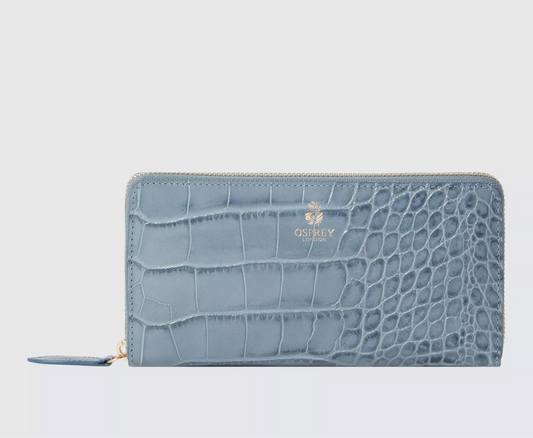 Blue crocodile-textured wallet on a light gray background